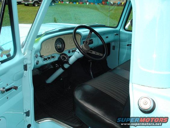 Light blue pickup truck interior with black seat and dashboard gauges