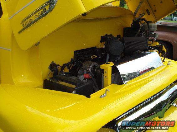 Yellow Ford F-series truck engine bay with 'POWER STROKE' cover. Visible 'FORD F600' badging