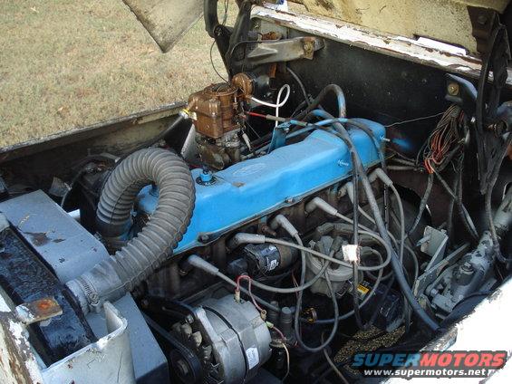 Engine bay with blue valve covers and carburetor