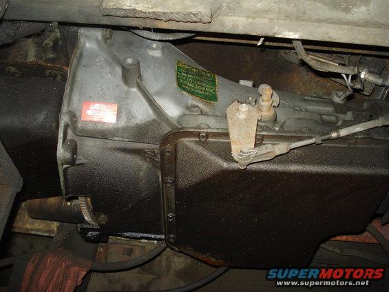 close-up of a vehicle's transmission pan and casing with labels