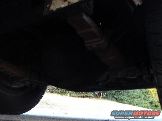 Underside view of truck leaf springs and tire