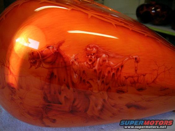 motorcycle gas tank with airbrushed art of a demon on a horse holding scales
