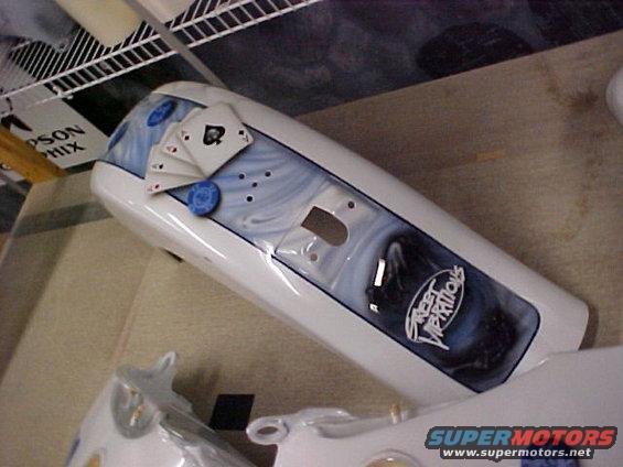 motorcycle fender painted with playing cards and blue swirls, has 'Street Vibrations' text