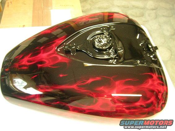 Motorcycle gas tank with black and red flame paint job, chrome fuel cap