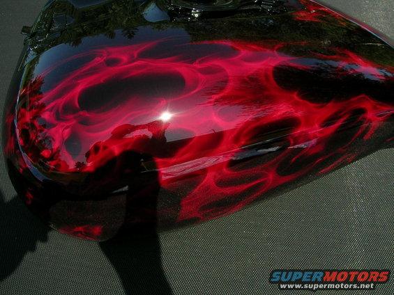 Motorcycle fuel tank with red and black flame paint job