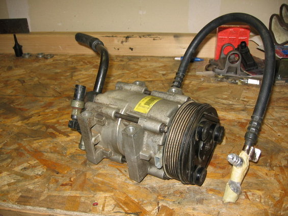 95-ac-compressor-pics-001.jpg All the pics for now are just of the stock '95 compressor I removed.  The idea is to use this location and put another compressor in there for OBA that is practically plug and play (for anyone interested in wanting this), vs. fabbing up pulley's, brackets, different sized belts, etc.