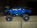 2008 Ford F-250 - RC monster truck with oversized tires is displayed on a couch.