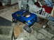 2008 Ford F-250 - A blue remote-controlled truck is positioned on a surface made of concrete blocks and debris.