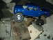 2008 Ford F-250 - This blue 2008 Ford F-250 RC truck is positioned on a surface covered with concrete debris.
