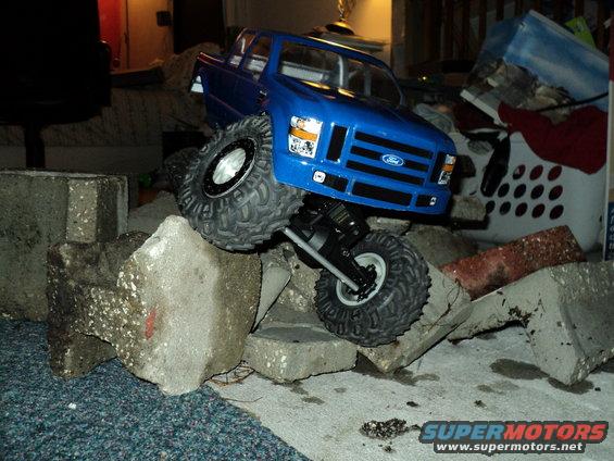 Blue RC Ford F-250 on concrete blocks
