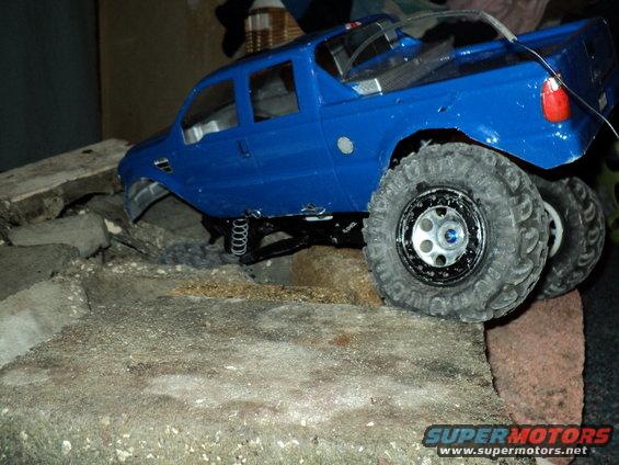 Blue remote control truck on rocky terrain