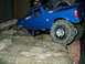 2008 Ford F-250 - This blue remote control truck is navigating a challenging obstacle course made of concrete and bricks.