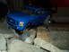 2008 Ford F-250 - A blue RC truck body resembling a Ford F-250 navigates a rocky obstacle course.