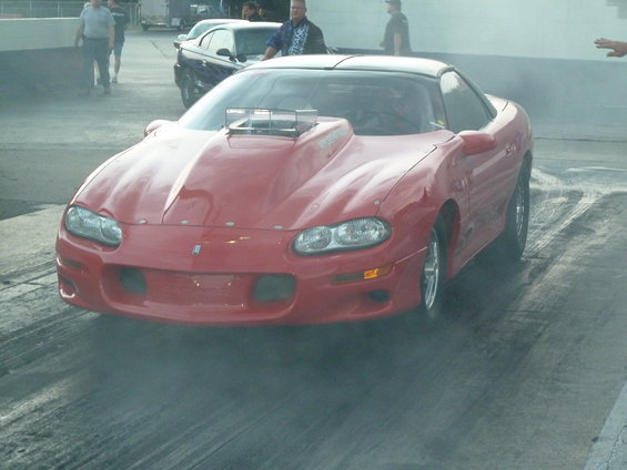Red 1997 Chevrolet Camaro drag car front view with hood scoop