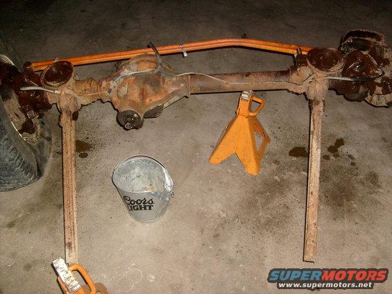 rear axle assembly on jack stands with a bucket