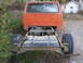 1973 Ford F-250 - Rear view of an orange pickup truck chassis with visible fuel tank and frame.