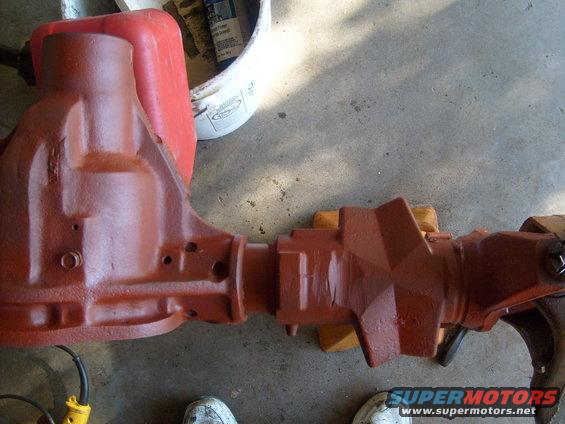 red differential housing with yellow tool and red gas can in background