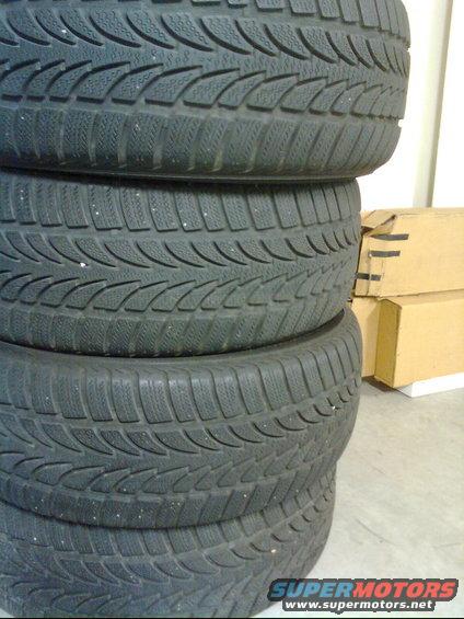 stack of four tires with winter tread pattern