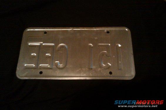 Blank metal license plate with embossed characters 'CEE 121'