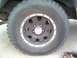 1987 Ford Bronco - Rear wheel with center caps.