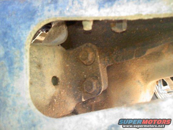 Close-up of rusty suspension component with bolts