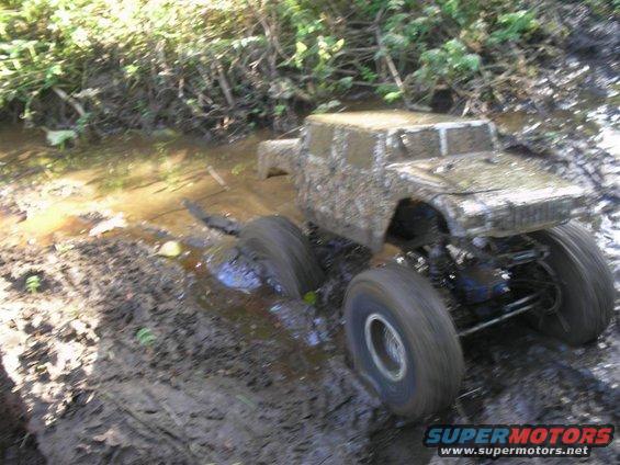 Vehicle stuck in mud, side view