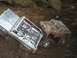 1994 Ford Escort - Two remote control trucks are stuck in thick mud, with one appearing to be silver and the other brown.