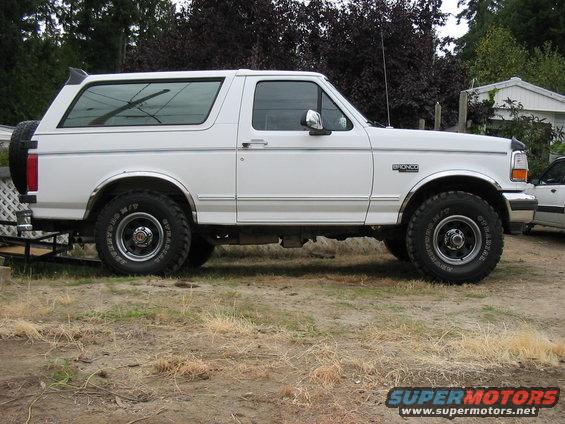 White 1995 Ford Bronco side view with new tires