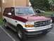 1993 Ford Bronco - This two-tone 1993 Ford Bronco is captured in a 3q front view, highlighting its classic grille and body style.
