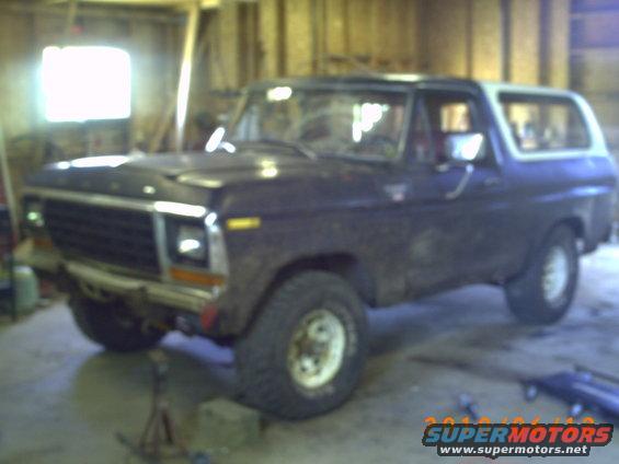 Ford Bronco in garage, front end visible. It has a white removable top