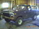 1979 Ford Bronco - This Ford Bronco is parked inside a garage, possibly undergoing maintenance or storage.