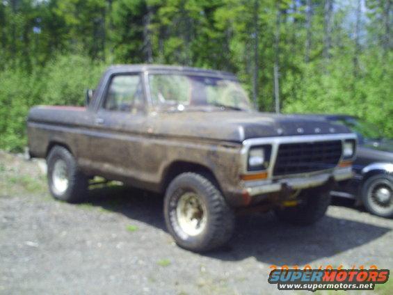 Brown 1978 Ford Bronco with a dirty exterior parked on gravel