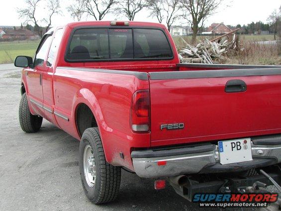 Red Ford F-250 pickup truck, rear view