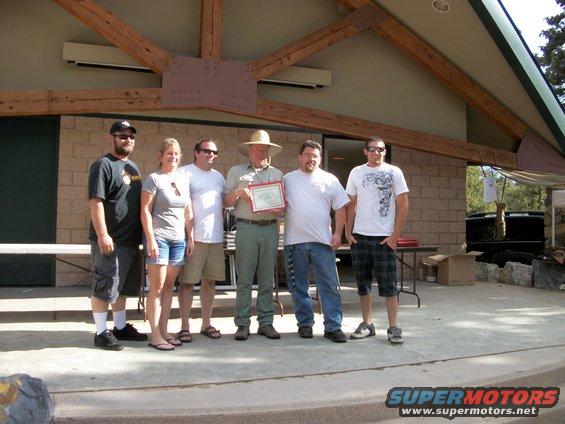 Group receiving an award outdoors