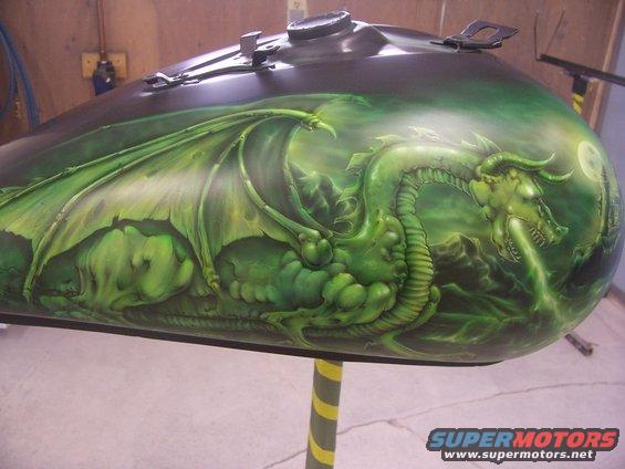 motorcycle gas tank with green dragon airbrushed on it