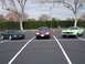 1971 Ford Mustang - A light green 1971 Ford Mustang Mach 1 is parked in a lot with two other cars.