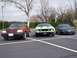 1971 Ford Mustang - A light green 1971 Ford Mustang is parked in a lot with two other vehicles. The Mustang features a distinctive grille and hood scoops.