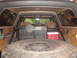 1989 Ford Bronco - The interior of this 1989 Ford Bronco features a custom tire carrier and spare tire mounted in the cargo area.