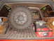 1989 Ford Bronco - Spare tire and recovery gear stored in the cargo area of a vehicle.