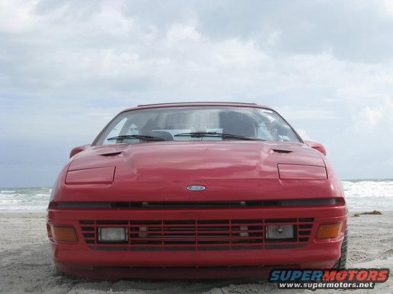 Red 1994 Ford Probe front view on a beach