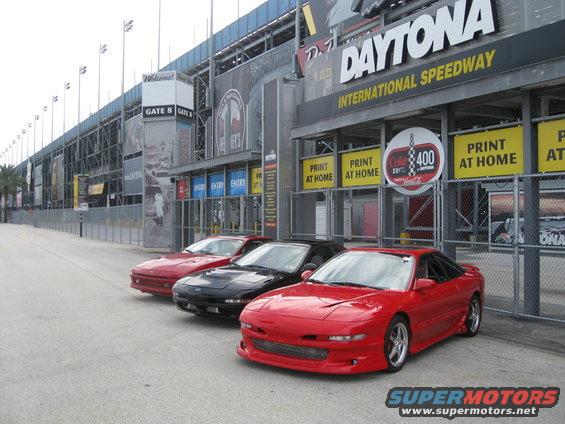 Three Ford Probe cars parked outside Daytona International Speedway