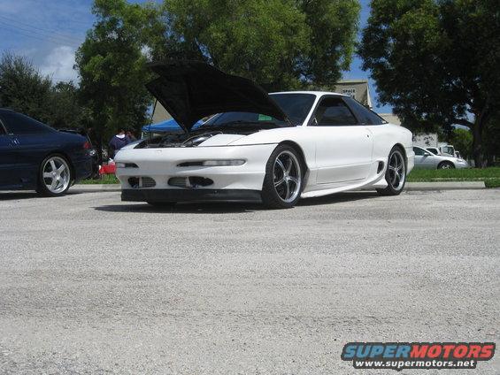White 1994 Ford Probe with hood open, parked next to a blue car