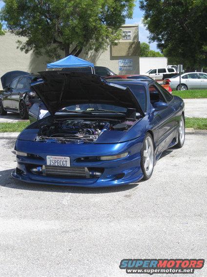 Blue coupe with hood open, showing engine and intercooler