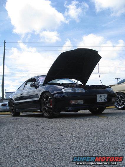 Black coupe with hood open, Japanese license plate