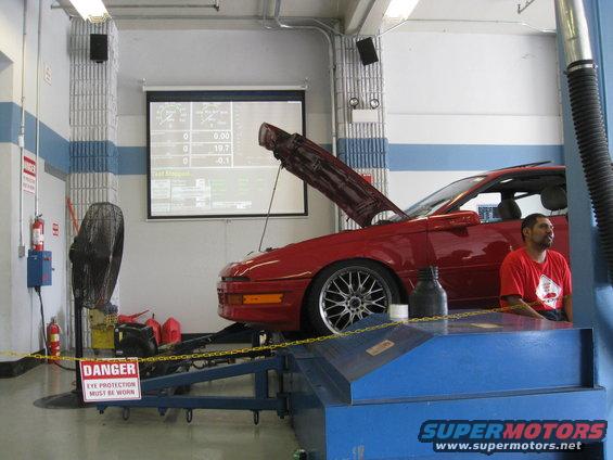 1994 Ford Probe on a dynamometer with hood open, screen displaying data