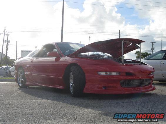 Red 1994 Ford Probe with hood open, front 3/4 view