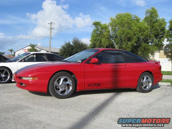 Red 1994 Ford Probe GTS parked next to a white car