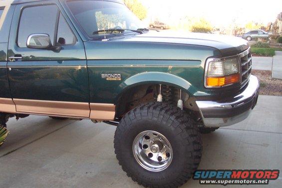 Green 1995 Ford Bronco with tan trim and lifted suspension