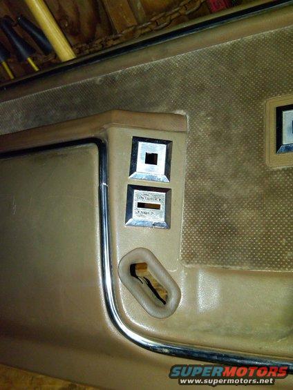 Interior door panel showing window lock and unlock switches, and a door handle