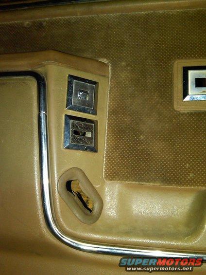 Interior door panel with two window switches and a door lock mechanism